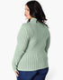 A woman shown from the back wearing a sage green ribbed knit sweater and dark blue jeans against a plain white studio background.