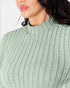 Close-up of a model wearing a ribbed knit mock neck top in a muted sage green color.