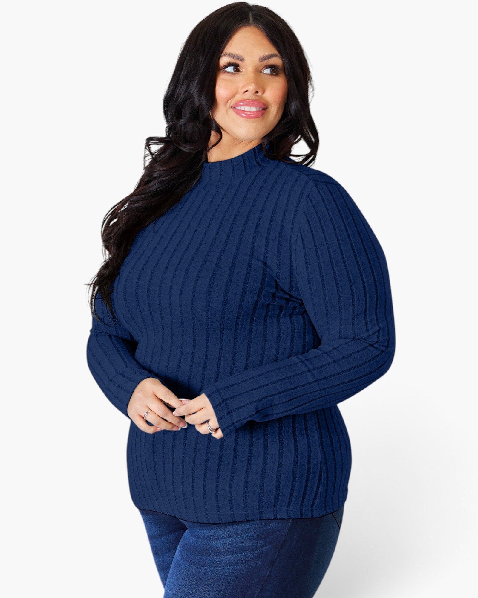 A woman modeling a navy blue ribbed mock neck sweater against a plain white background.