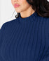 Close-up of a woman wearing a navy blue ribbed knit mock neck sweater, showing the texture of the fabric and the collar detail.