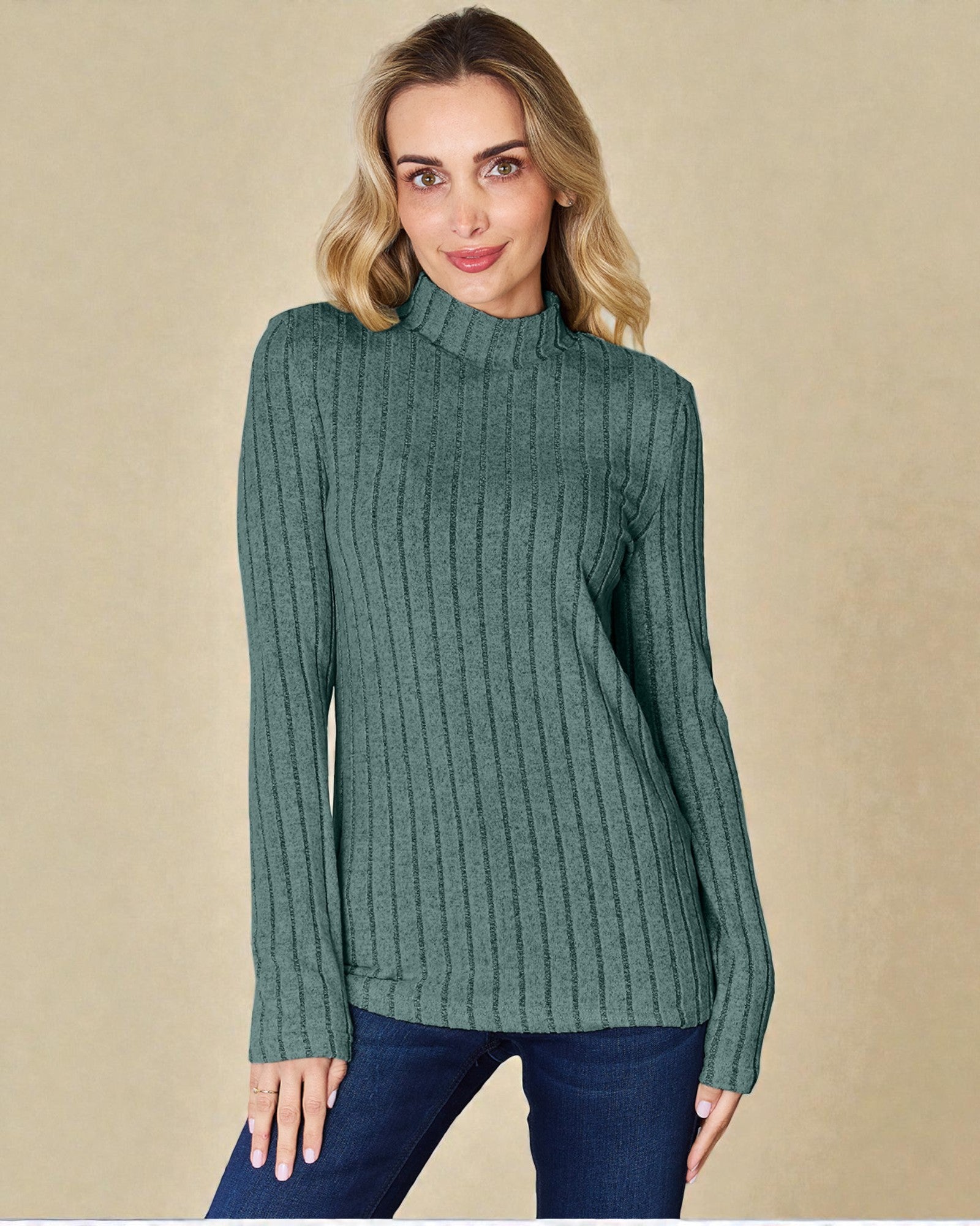 Woman wearing a green ribbed sweater against a beige background