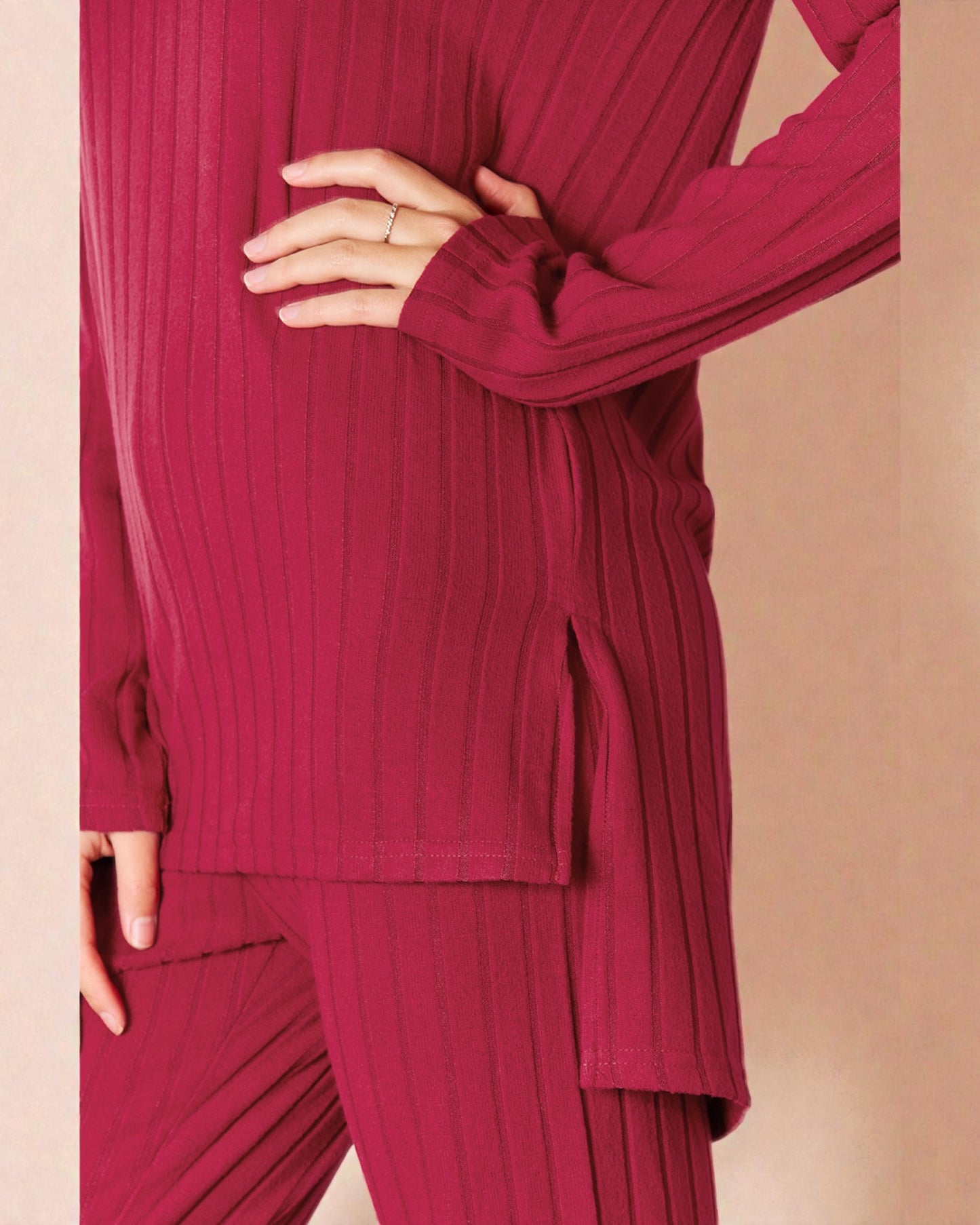 Person wearing a ribbed red outfit on a beige background