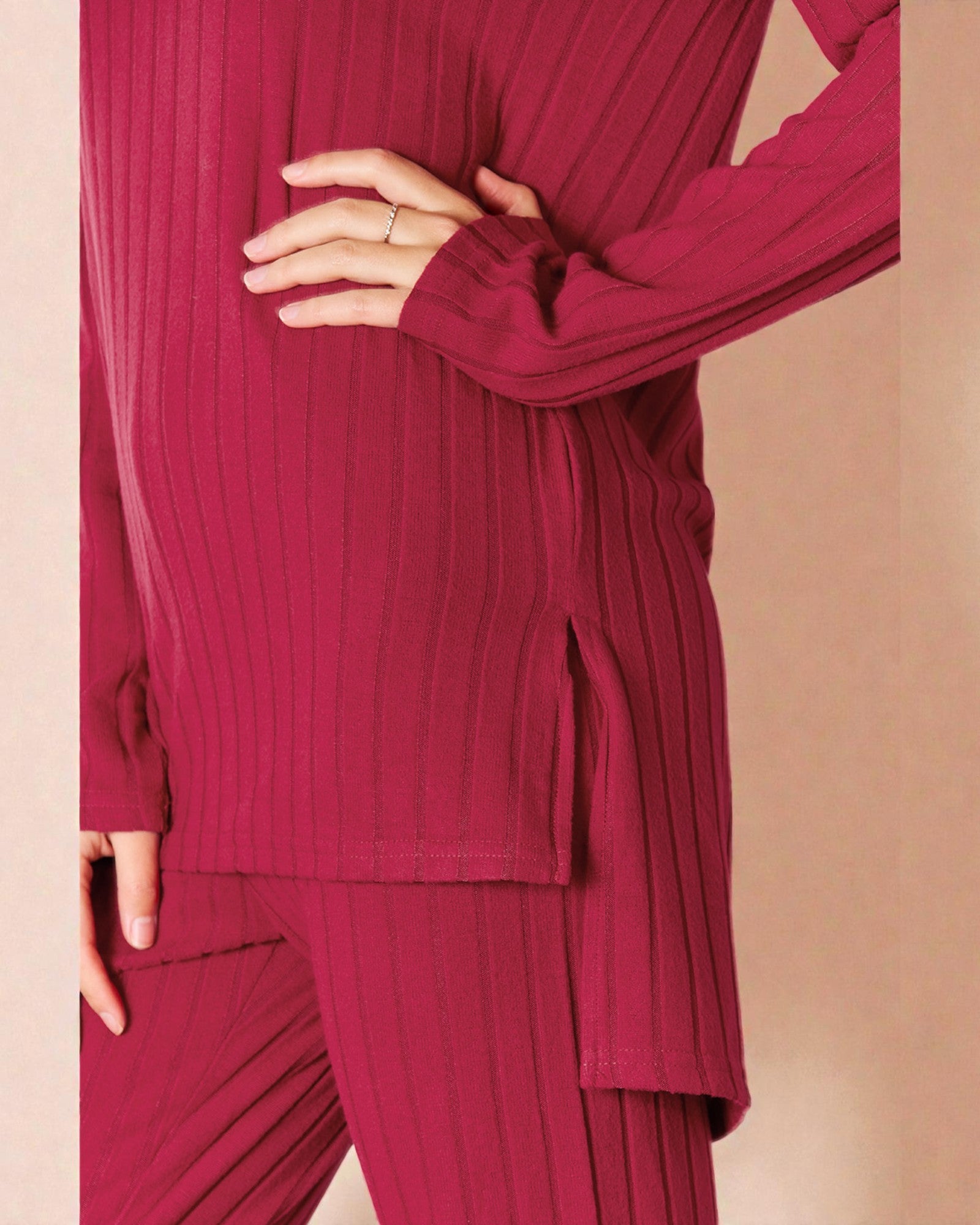 Person wearing a ribbed red outfit on a beige background