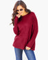 A woman wearing a ribbed knit long-sleeve sweater in deep burgundy, paired with blue jeans and sunglasses, against a plain white background.