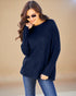 Woman wearing a navy sweater and blue jeans against a beige background