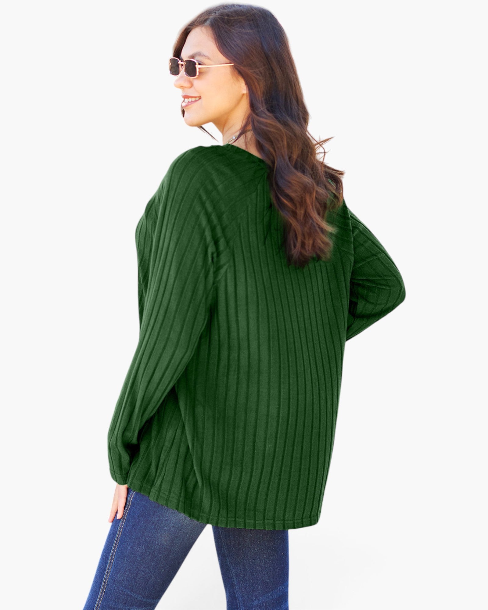 A woman wearing a dark green ribbed knit sweater and blue jeans, photographed from the back against a plain white background.