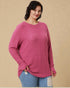 Woman wearing a pink ribbed sweater against a beige background