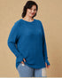 Woman wearing a blue sweater against a beige background