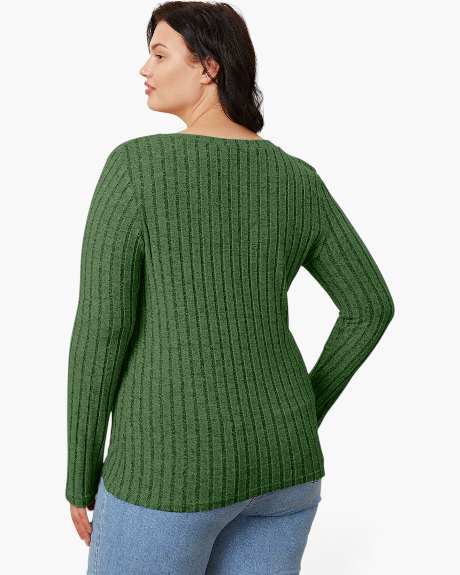 A woman shown from the back wearing a green ribbed knit sweater and light blue jeans against a plain white studio background.