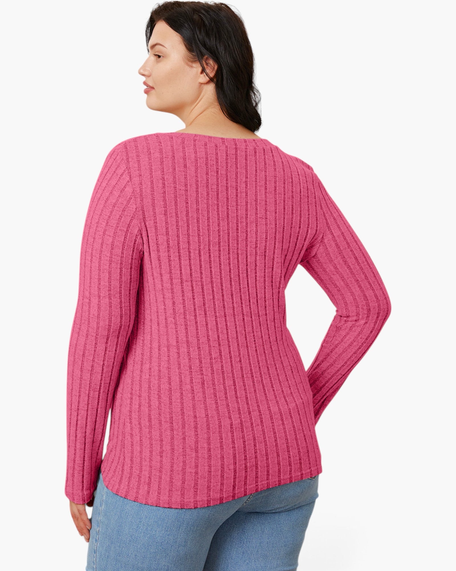 A woman shown from the back wearing a pink ribbed knit sweater and blue jeans against a plain light background.