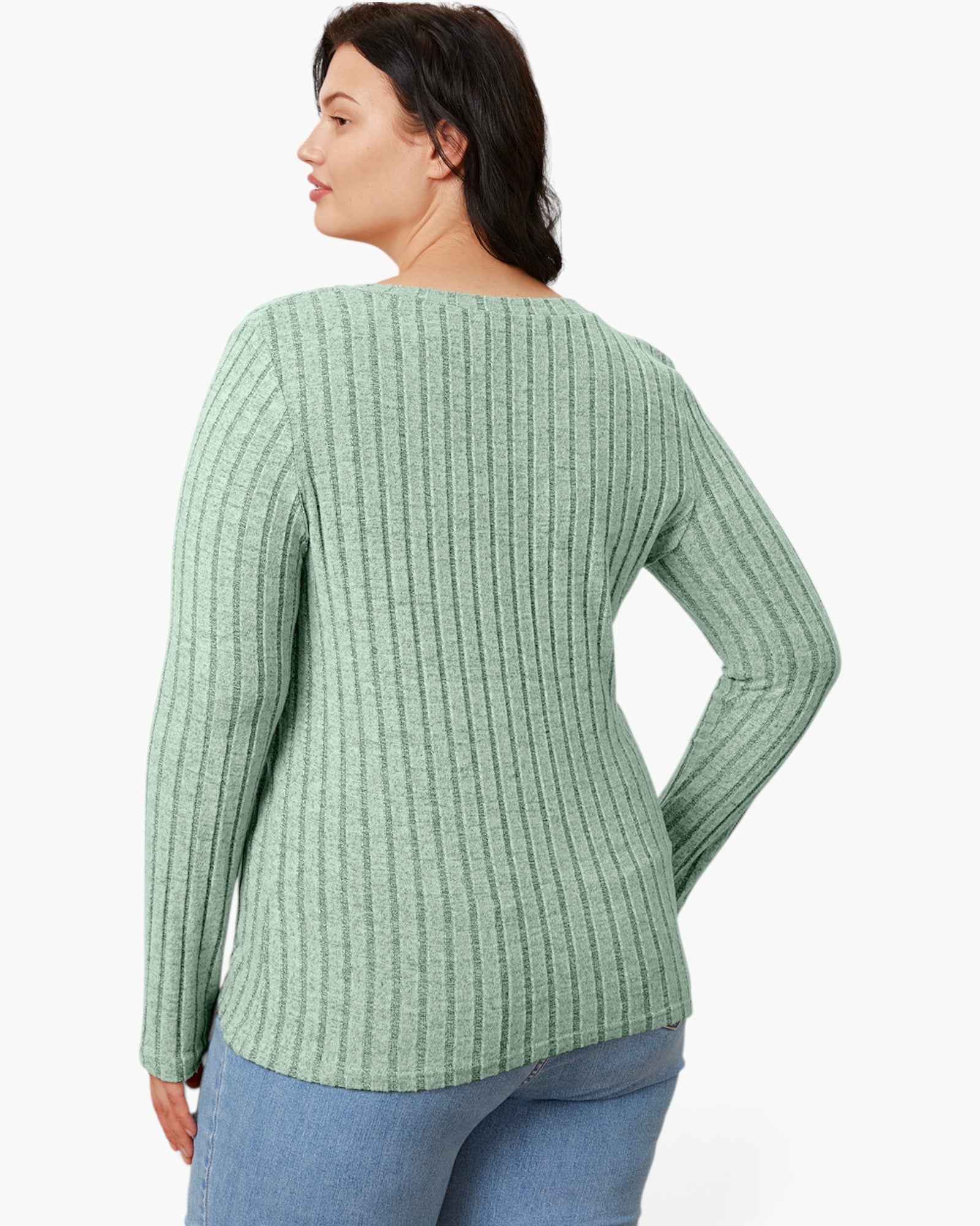 A woman shown from the back wearing a sage green ribbed knit sweater and blue jeans against a plain white background.