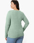 A woman shown from the back wearing a sage green ribbed knit sweater and blue jeans against a plain white background.
