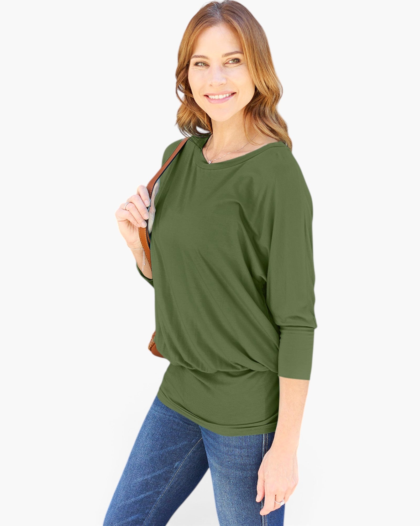 A woman modeling an olive green three-quarter sleeve top with a relaxed, slightly draped fit, paired with blue jeans against a plain white background.