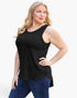 A woman modeling a black sleeveless scoop-neck tank top with a curved hem, paired with blue jeans, against a plain white background.