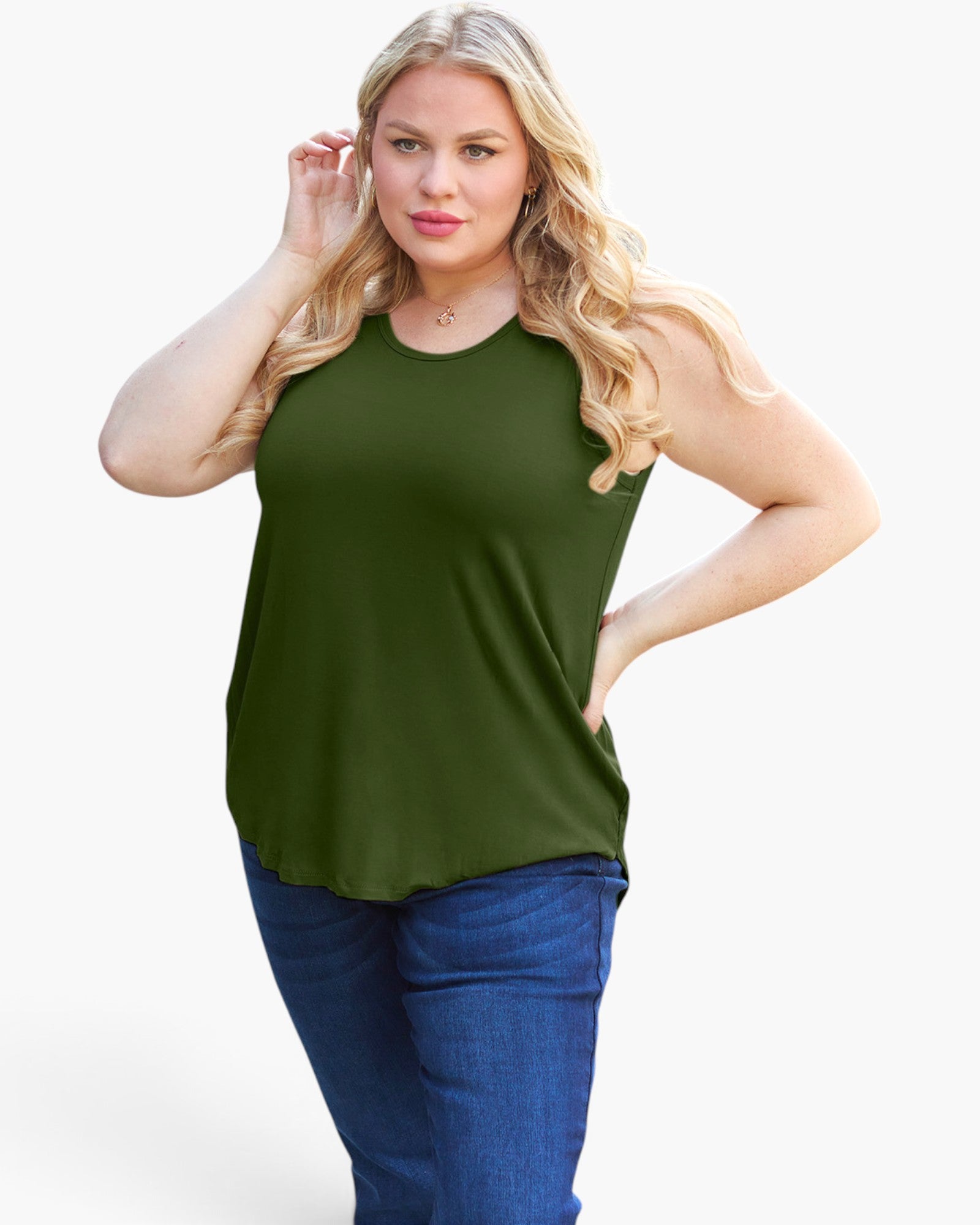 A plus-size blonde woman wearing an olive green sleeveless tank top and blue jeans, posing against a light gray studio background.