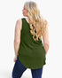 A woman with long blonde wavy hair is shown from the back wearing an olive green sleeveless tunic top and dark blue jeans against a plain white background.
