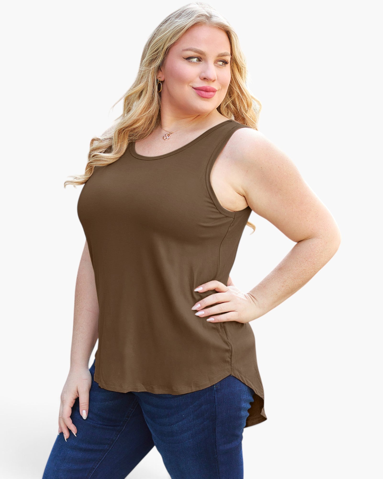 A woman modeling a sleeveless scoop-neck tank top in a solid brown color, paired with dark blue jeans, against a plain white studio background.
