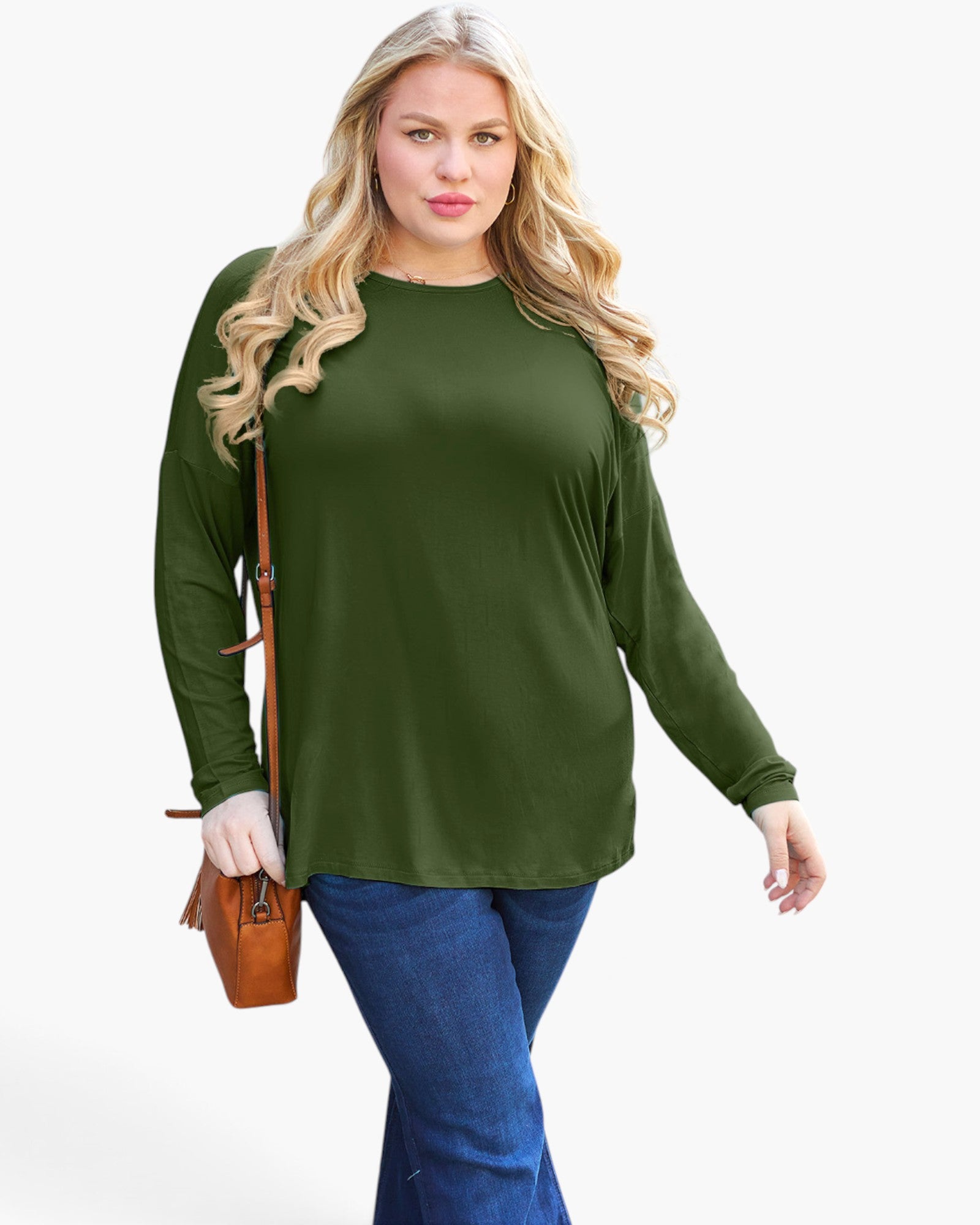 A woman modeling a long-sleeve crewneck top in olive green, paired with blue jeans and carrying a small brown crossbody bag, against a plain light gray background.
