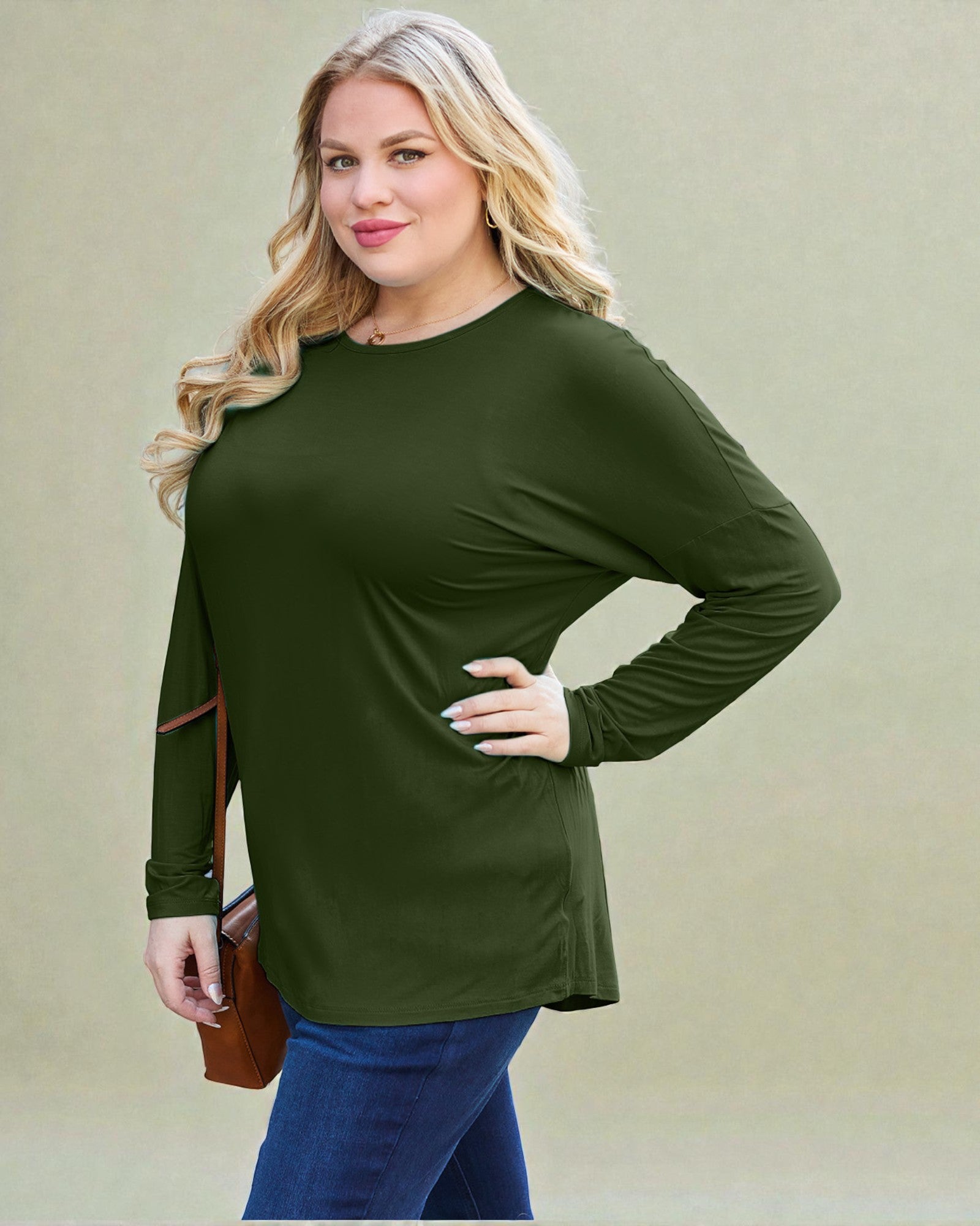 Woman wearing an olive green long-sleeve top against a beige background