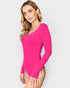 Woman wearing a bright pink long-sleeve swimsuit against a white background