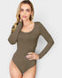 Woman wearing a brown long-sleeve bodysuit against a white background