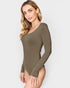 Woman wearing a green long-sleeve bodysuit on a white background