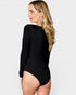 Woman wearing a black long-sleeve bodysuit on a white background