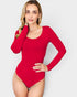 Woman wearing a red long-sleeve bodysuit against a light gray background