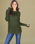 Woman wearing an olive green long-sleeve top and blue jeans against a beige background