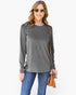 A woman modeling a heather gray long-sleeve crewneck top with blue jeans, sunglasses, and a brown crossbody bag against a plain white background.