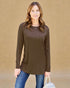 Woman wearing a brown long-sleeve top against a beige background