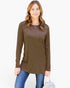 A woman modeling a brown long-sleeve tunic top with a chest pocket, paired with blue jeans, against a plain white background.