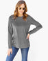 A woman modeling a heather gray long-sleeve top with blue jeans against a plain white background.