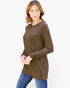 A woman modeling a brown long-sleeve tunic top with a chest pocket, paired with blue jeans, against a plain white background.