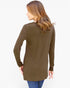A woman shown from the back wearing a long-sleeve olive brown tunic top with blue jeans, photographed against a plain white studio background.