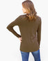 A woman shown from the back wearing a long-sleeve olive brown tunic top and blue jeans against a plain white background.
