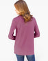 A woman shown from the back wearing a long-sleeve mauve purple top and blue jeans against a plain white background.