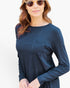 A woman wearing a dark navy blue long-sleeve t-shirt with a chest pocket, styled with round sunglasses against a plain white background.