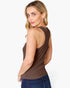 A woman wearing a brown sleeveless racerback tank top and blue jeans, shown from a three-quarters back view against a plain white studio background.
