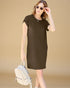 Woman wearing a brown dress holding sunglasses and a white backpack against a beige background
