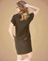 Woman wearing a brown dress against a beige background