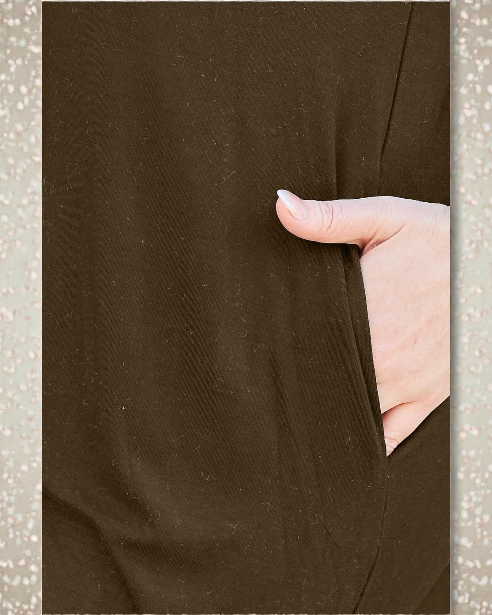 Brown fabric with a hand pushing against it