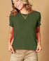 Woman wearing a green t-shirt and beige pants against a beige background