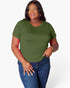 A woman modeling a short-sleeve crewneck t-shirt in olive green, paired with blue jeans, against a plain light gray background.