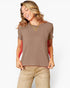 A woman wearing a short-sleeve crewneck t-shirt in a muted taupe-brown color, paired with beige pants, against a plain white studio background.