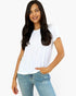 A woman modeling a white short-sleeve crewneck t-shirt paired with light-wash blue jeans, set against a plain white studio background.