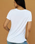 Woman wearing a white t-shirt against a beige background