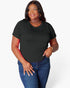 A woman modeling a black short-sleeve crewneck t-shirt paired with blue jeans, standing against a light gray studio background.