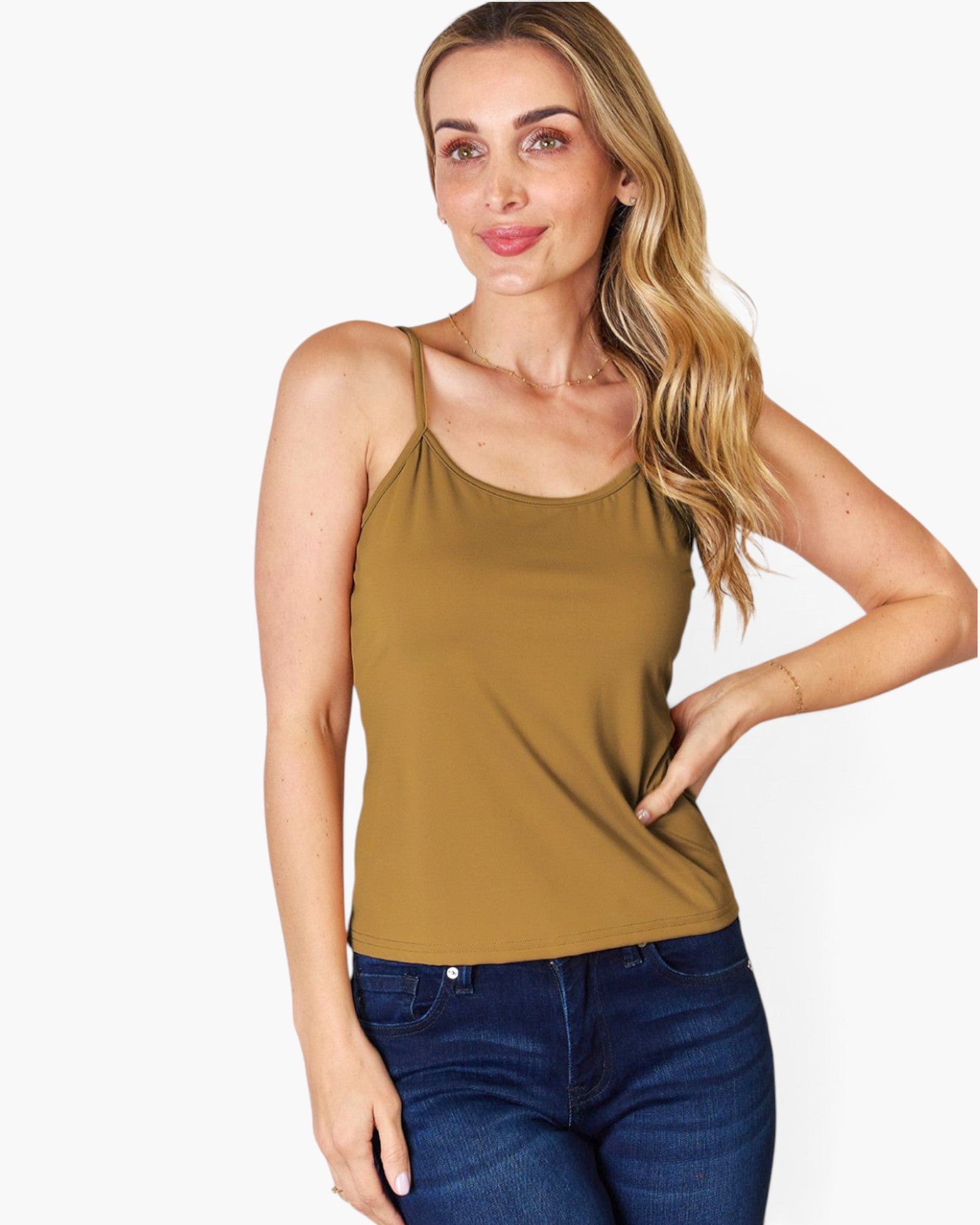 A woman modeling a sleeveless olive-brown camisole tank top paired with dark blue jeans, set against a plain light gray background.