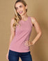 Woman wearing a pink tank top and blue jeans against a beige background
